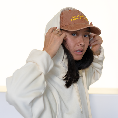 'toujours en construction' brown hat