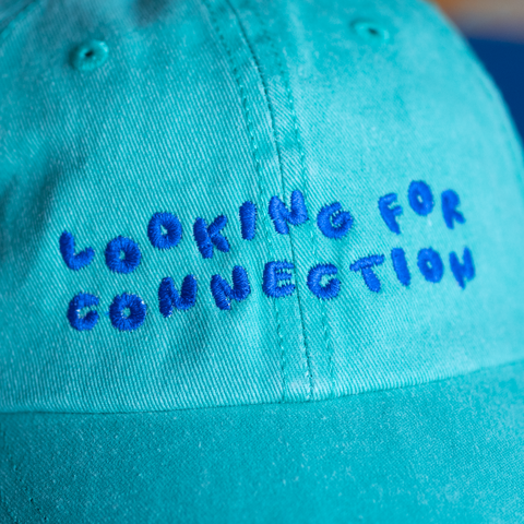 'looking for connection' green hat
