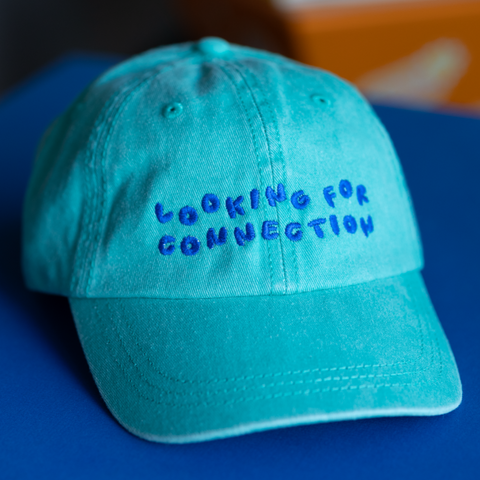 'looking for connection' green hat